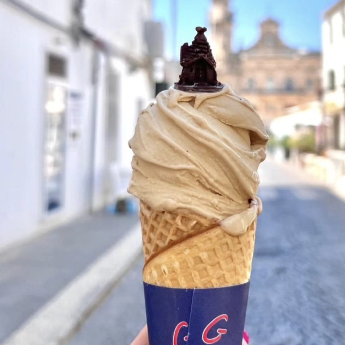 Gelateria Artigianale Ice Dream gelato cone in Ostuni with Piazza Sant'Oronzo in the background